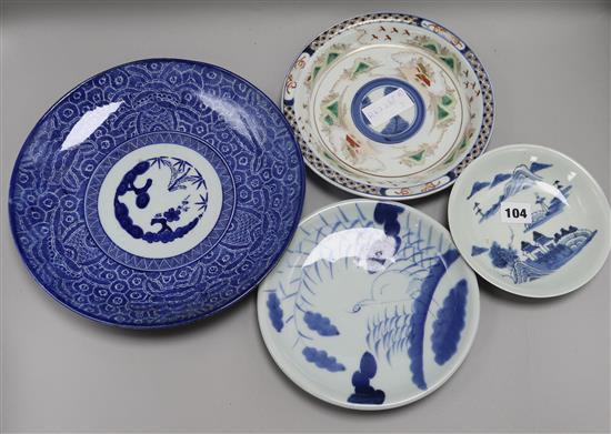A Japanese blue and white plate, two others, a polychrome plate, a Japanese charger and a cinnabar lacquer vase charger 46.5cm diameter